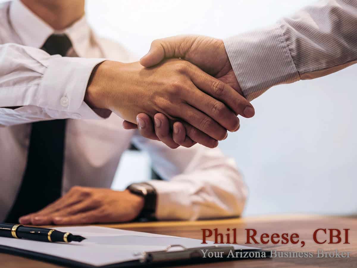A business broker shaking hands with a client in Scottsdale